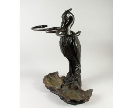 A GOOD 19TH CENTURY CAST IRON STICK STAND, POSSIBLY COALBROOKEDALE, "Heron and the Serpent" model, with detachable shell shap