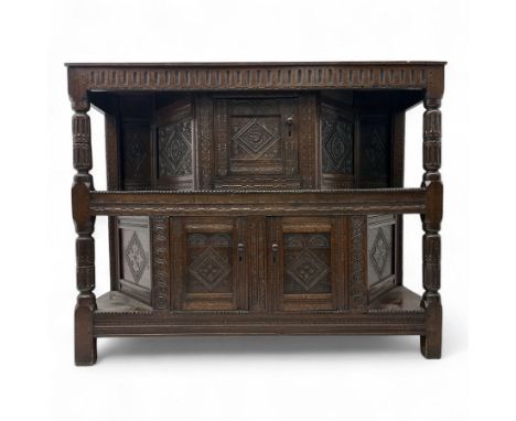 Early 20th-century  oak Jacobean two-tier revival court cupboard, rectangular top with carved notch and stylized foliate carv