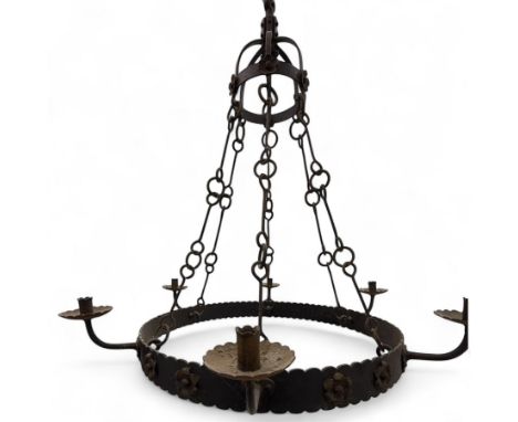 Mid-20th-century wrought iron Gothic revival chandelier, dome-shaped mount, above frame with circular scalloped edges and pet