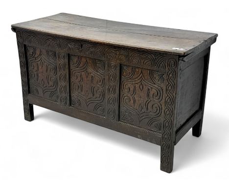 English carved oak coffer, hinged rectangular lid with indented side edges, internal candle-box, front with three-panel front