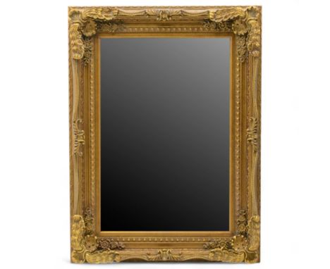 Late 19th century gilt composition overmantel mirror, rectangular bevelled plate within a foliate and acanthus scroll moulded