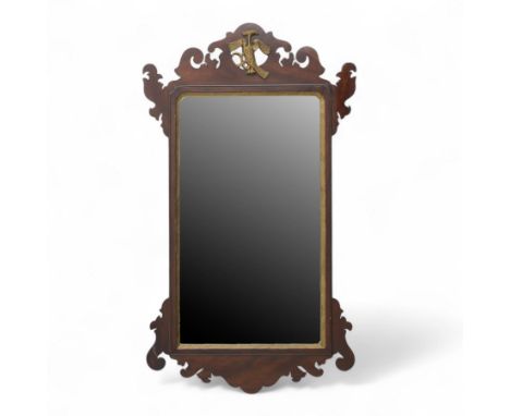 Chippendale style mahogany wall mirror, with shaped and fret carved surround enclosing a rectangular bevelled mirror plate, p