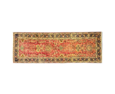 North West Persian Tabriz runner, the madder field with central floral medallion and scrolling palmette motifs, flanked by pe