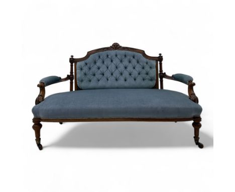 Victorian button upholstered walnut two-seater settee, arched carved top rail and finials, with velvet cushion back above uph