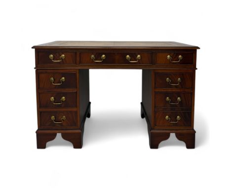Contemporary mahogany pedestal desk, rectangular top inset with tooled and gilt bordered tan leather skiver, arrangement of e