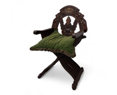 Late 19th century Anglo-Indian hardwood savonarola chair, the pierced and carved back inlaid with brass and bone motifs, shap