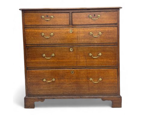 George III oak chest of drawers, the top with a moulded edge above an arrangement of two short over three long drawers, each 