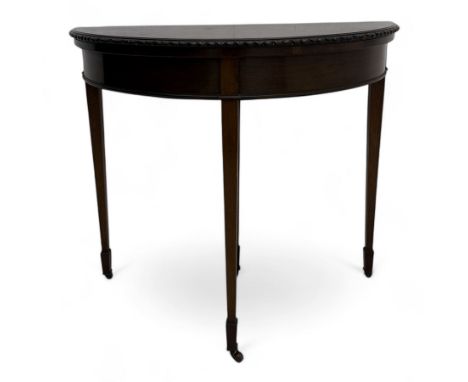 Early 20th century mahogany demi-lune card table, fold-over swivel top revealing baize lined interior, carved gadroon edge, o