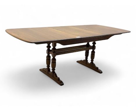 Ercol - late 20th century oak refectory dining table, rectangular top with rounded corners and central extending leaf, raised