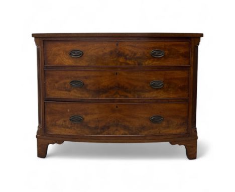 Early 19th century mahogany bow front chest of drawers, with three cockbeaded long drawers fitted with oval brass plate handl