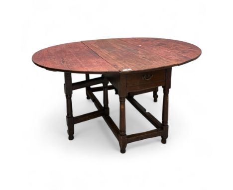 19th century oak gateleg table, oval top, twin hinged top above a frieze drawer to one end, over a plain apron, on four ring-