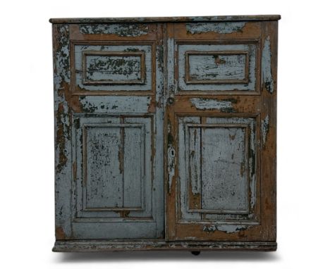 Early 20th century painted pine wall cupboard, with overhanging top above a pair of inset moulded panel doors, distressed pai