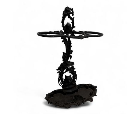 Victorian cast iron stick stand, pierced and scrolled frame with twin umbrella or cane loops, surmounted by a lion mask and f