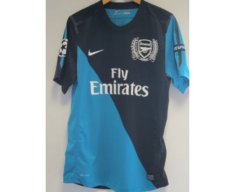 MIKEL ARTETA ARSENAL MATCH WORN SHIRT    A blue and turquoise short sleeve shirt with Arteta 8 on the back and Champions Leag