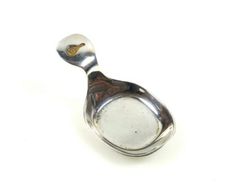 Contemporary silver caddy spoon "The Millennium Spoon" with a rounded rectangular bowl and a gold plated eagle's wing inset i