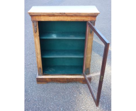 Victorian inlaid walnut pier cabinet, with a glazed panelled door enclosing 3 shelves, flanked by gilt metal mounts, on a sha