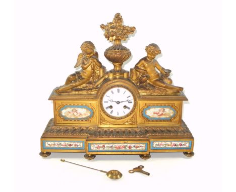 Late 19th Century French ormulu mantel clock, the circular white enamelled dial with black Roman numerals, inscribed "F. Glad