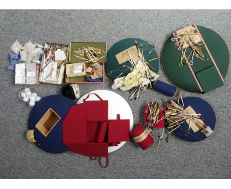 Four round bobbin lacemaking pillows, Dia.50.5cm the largest; a good quantity of bobbins, needles, and other related items. (