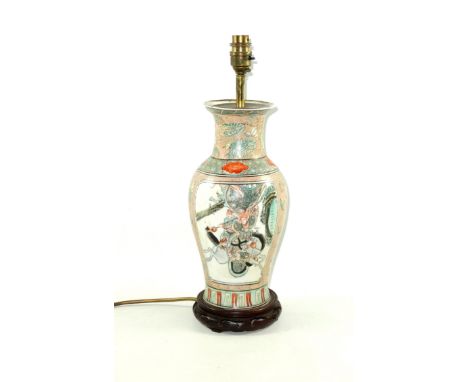 Chinese porcelain baluster vase, converted to a lamp, painted with reserves of warriors, on a stippled pale salmon ground wit