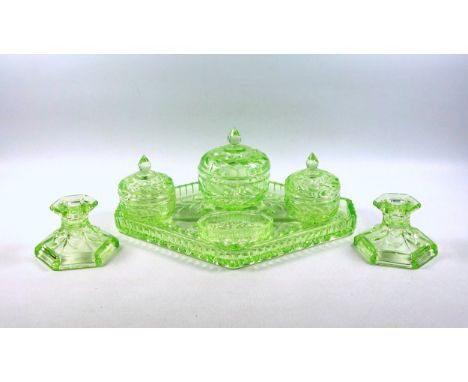 Uranium moulded glass dressing table set with floral decoration comprising 3 circular bowls, each with a domed cover, and a p