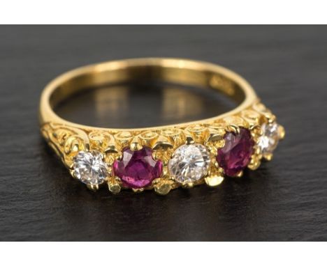 An 18ct yellow gold, ruby and diamond five stone ring hallmarked London 1987, the three graduated round brilliant cut diamond