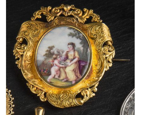 A Victorian 18ct yellow gold and enamel brooch unmarked but tested, the elaborate foliate engraved mirror-shaped frame centre
