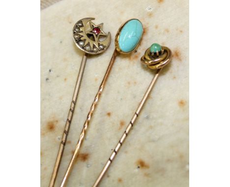 A 9ct gold, ruby and seed pearl crescent moon stick pin the moon set with seven graduated seed pearls, surmounted by a star c