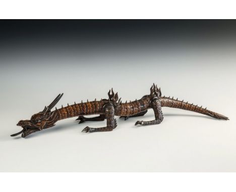 A Japanese carved and articulated wooden dragon Meiji period (1868-1912), probably boxwood, the body of twenty-six overlappin