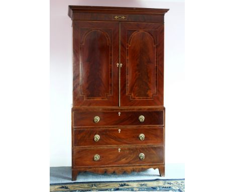 A good Regency Channel Islands inlaid mahogany linen press the flared moulded pediment with brass, boxwood and rosewood inlai