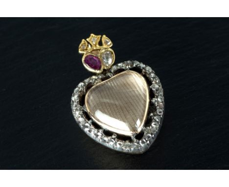 A Victorian heart shaped yellow gold, rock crystal, ruby and diamond pendant the double sided pendant with cabochon rock crys