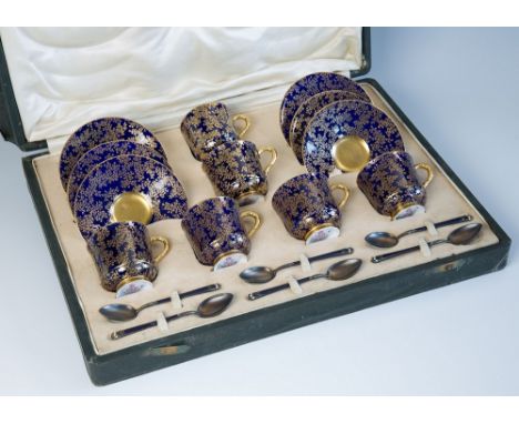 A cased set of Royal Worcester coffee cups and saucers with puce factory marks, date code 1925, blue ground with overall gild