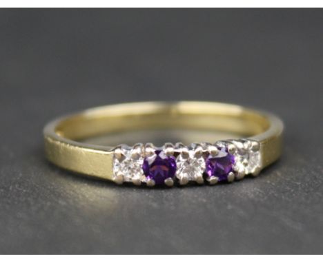 An 18ct yellow gold, amethyst and diamond five stone ring with two round cut amethysts alternating with three round brilliant