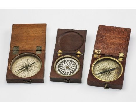 Two Georgian compasses both in square hinged mahogany cases enclosing glazed thirty-two wind paper bases, blue steel needles 