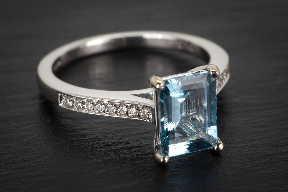 An 18ct White Gold Aquamarine And Diamond Ring The 1 3 Carat Emerald Cut Aquamarine In A Four Cl