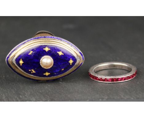 An antique yellow gold, silver, enamel and pearl ring the eye shaped ring in dark blue enamel with gold star pique work, cent