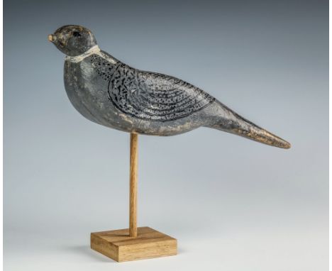A primitive folk art pigeon decoy late 19th century, carved wooden body painted grey with white collar, black painted plumage