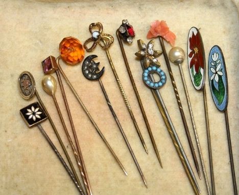 A collection of fourteen stick pins early to mid-20th century, including enamelled, paste set, pearl, coral and sterling silv