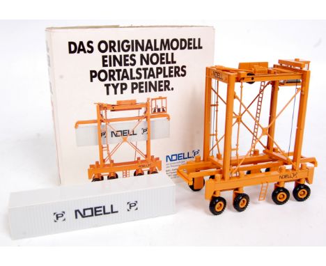 Noell 1/87th scale diecast model of a Noell Straddle Container Carrier, finished in orange with Noell livery, with Noell whit