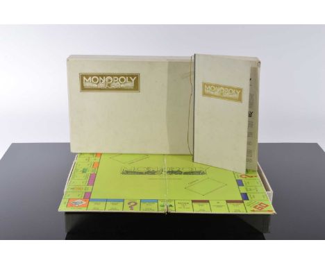 A c1970s Monopoly De Luxe board game, has been well loved