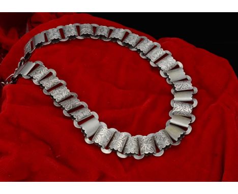 A Victorian silver engraved flattened linked necklace,  united by a plain oval linked chain and barrel clasp, 23 cm together,