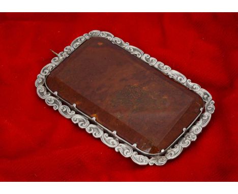 A large Victorian silver and red jasper ware brooch, the rectangular panel cushion cut, in a claw setting, surrounded by a sc