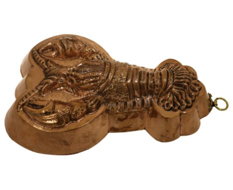 A 19th century French copper jelly mould, modelled as a crayfish or lobster, brass suspension ring, 7cm high, 26.5cm long.