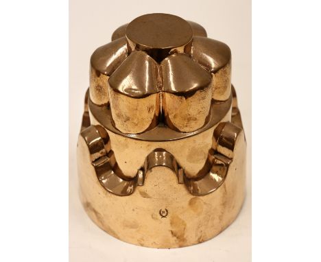 A 19th century French copper circular tiered jelly mould, hexagonal panelled top over scrolled crown base, makers mark P, sta