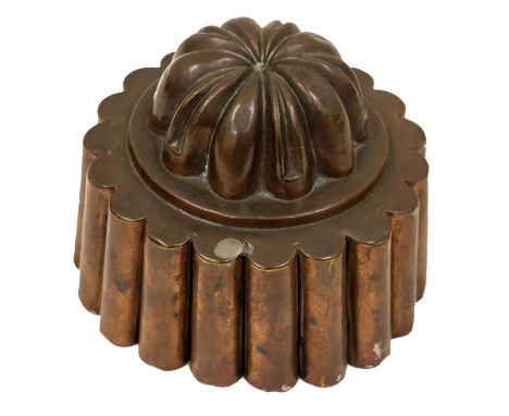 A Victorian copper circular shaped jelly mould, domed, lemon squeezer top, on flared fluted base, 11cm high, 14.5cm diameter.