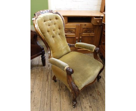 A mid Victorian carved walnut button back armchair