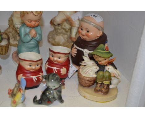 A Goebel figure, designed by MJ Hummel, Street Singer;  another, Village Boy;  Pet Rabbits, a Goebel boy praying;  two monk c