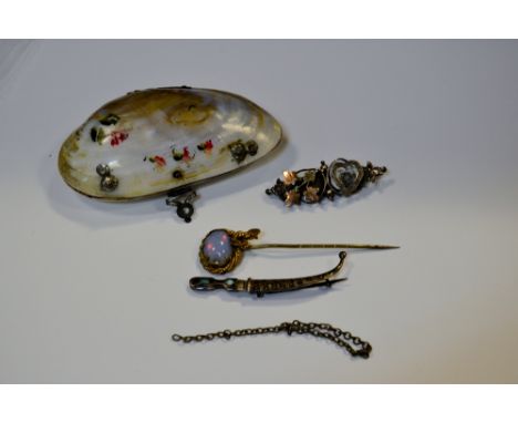 A silver sweetheart brooch;  a shell purse;  a stick pin;  a silver jambaya brooch