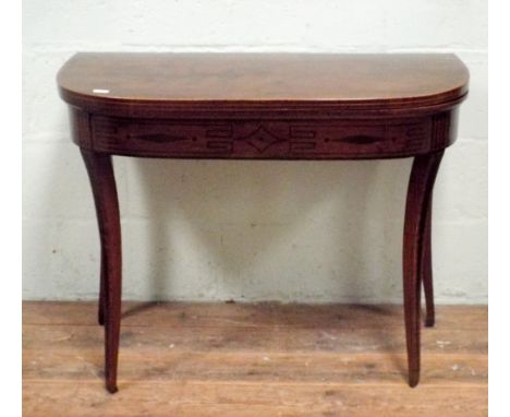 A Georgian D shaped inlaid mahogany folding top card table on taper sabre style legs, 92cms wide