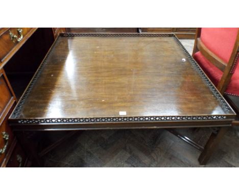 A large square Chippendale style coffee table with cross stretcher base and pierced gallery 108cm square