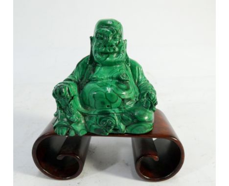 A carved Malachite Chinese figure of seated Buddha on associated scroll hardwood base 7cms tall